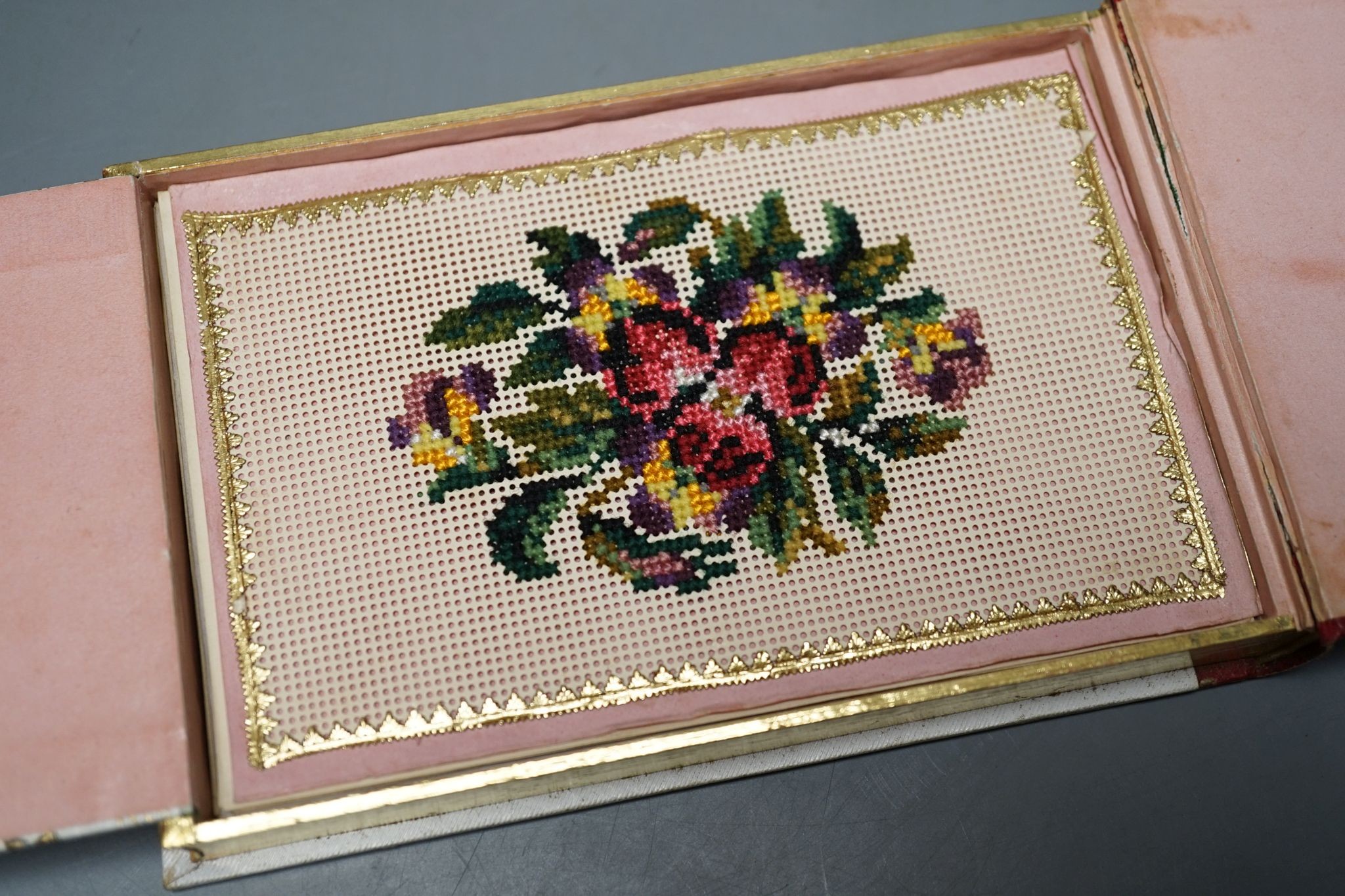 An Austrian beadwork cover souvenir album of watercolours and Berlin woolwork., 15 cms wide.